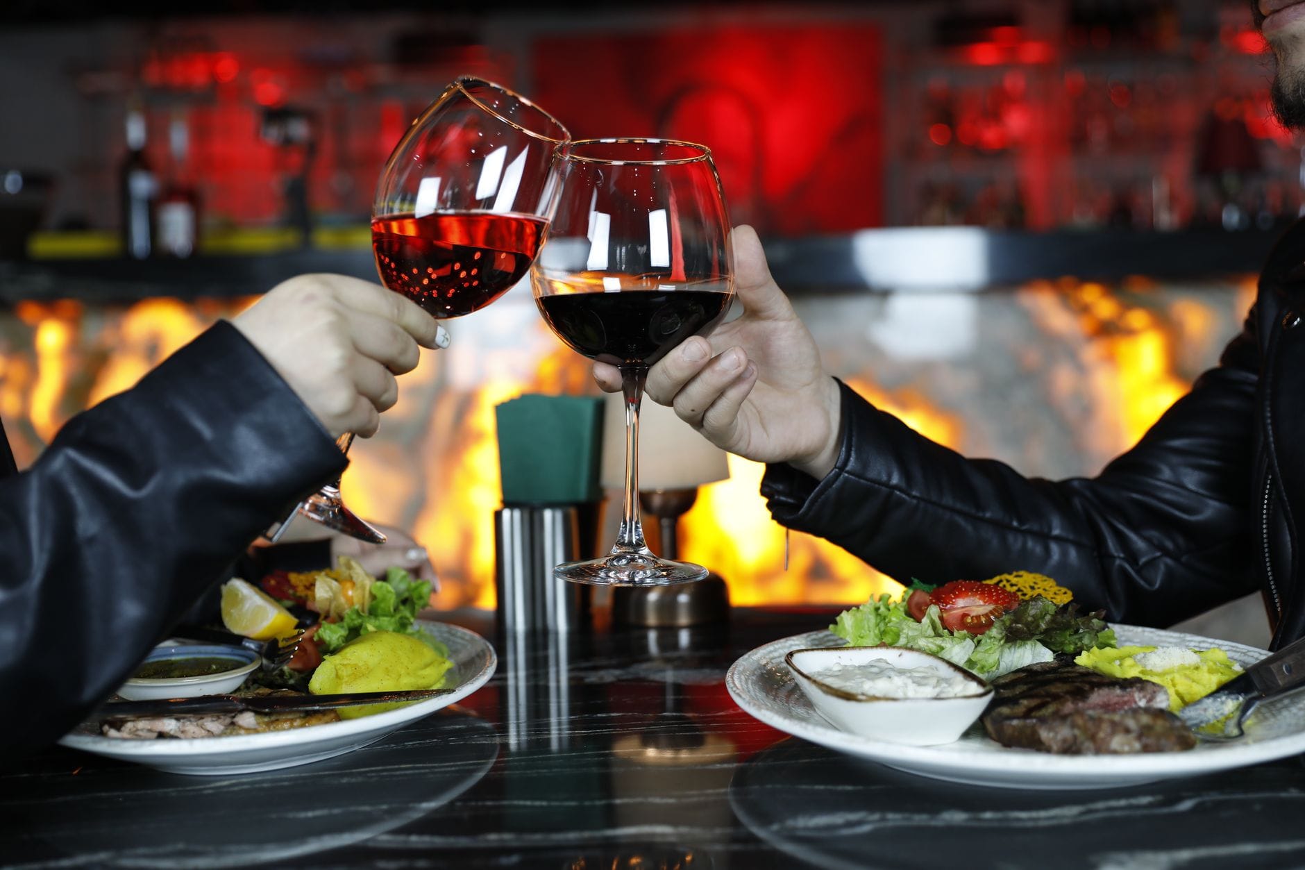 Para przy świecach pije czerwone wino w eleganckiej krakowskiej restauracji